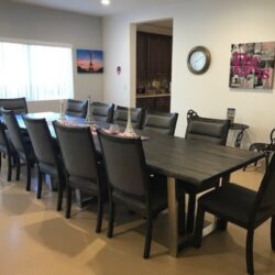 The dining room of an ICF/DD home in Reseda features a long table with 12 dining chairs.